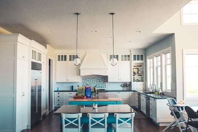 How are kitchen cabinets attached to the wall?